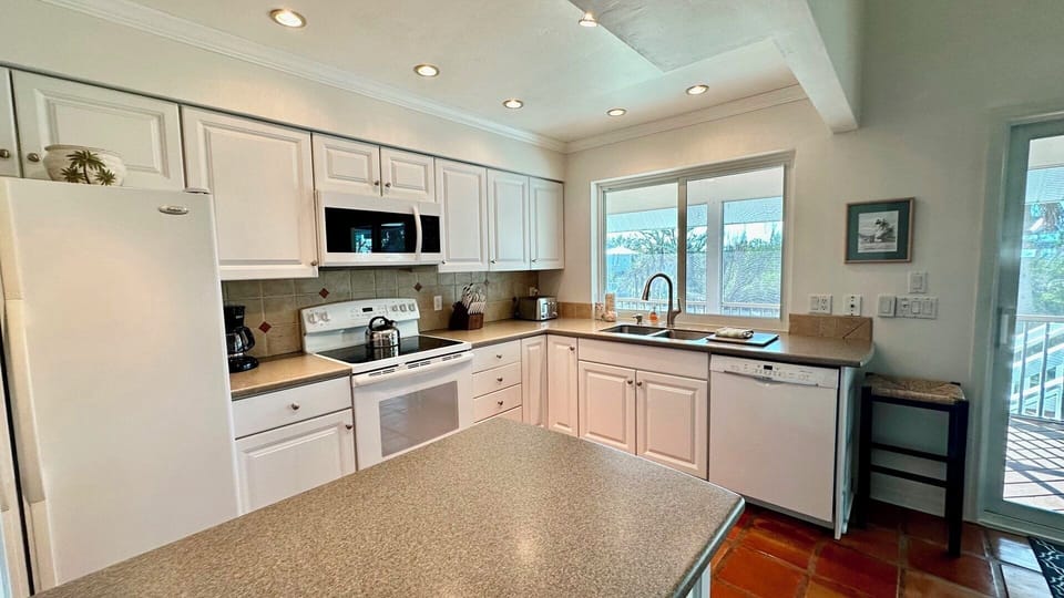 Fully-equipped kitchen, pass-through window to porch.