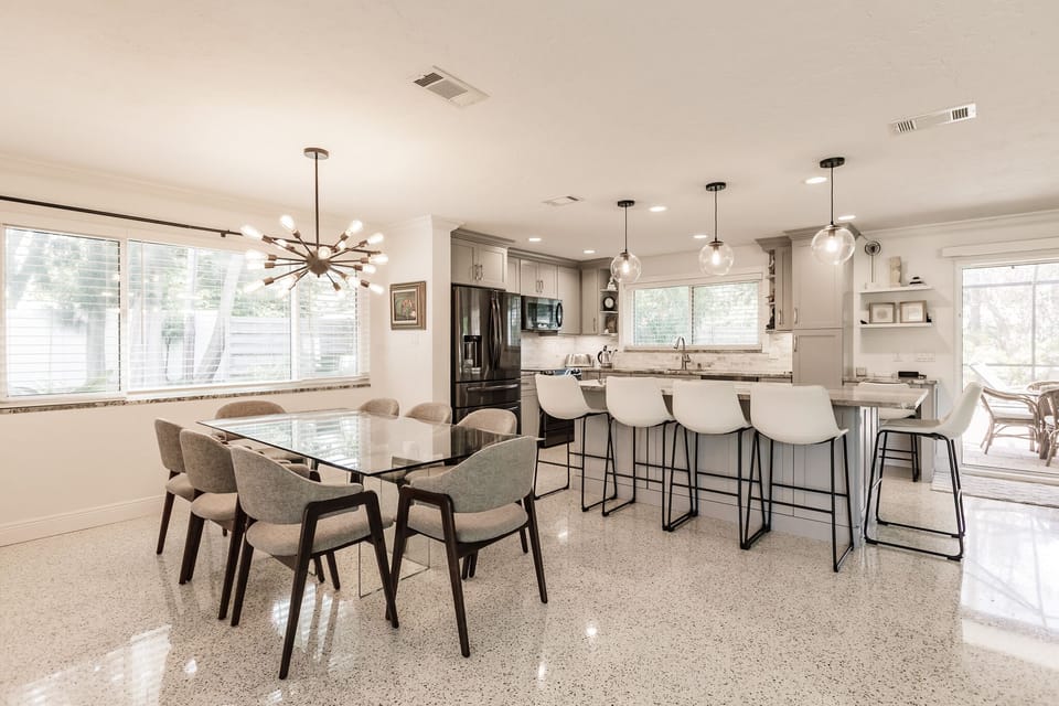 Dining area and kitchen with barstools