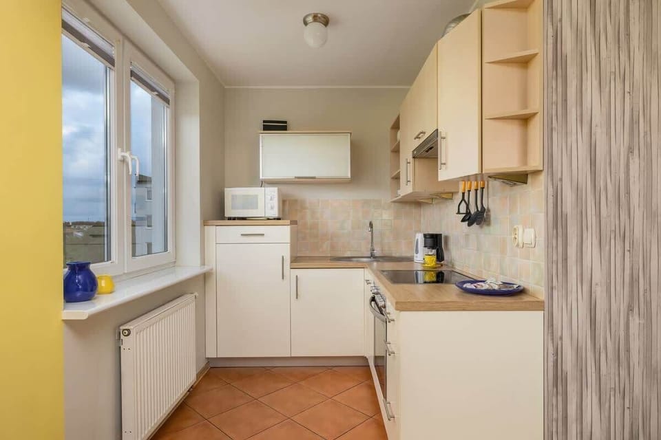 Another angle of the kitchen, showcasing its bright design and integration with the overall apartment decor.
