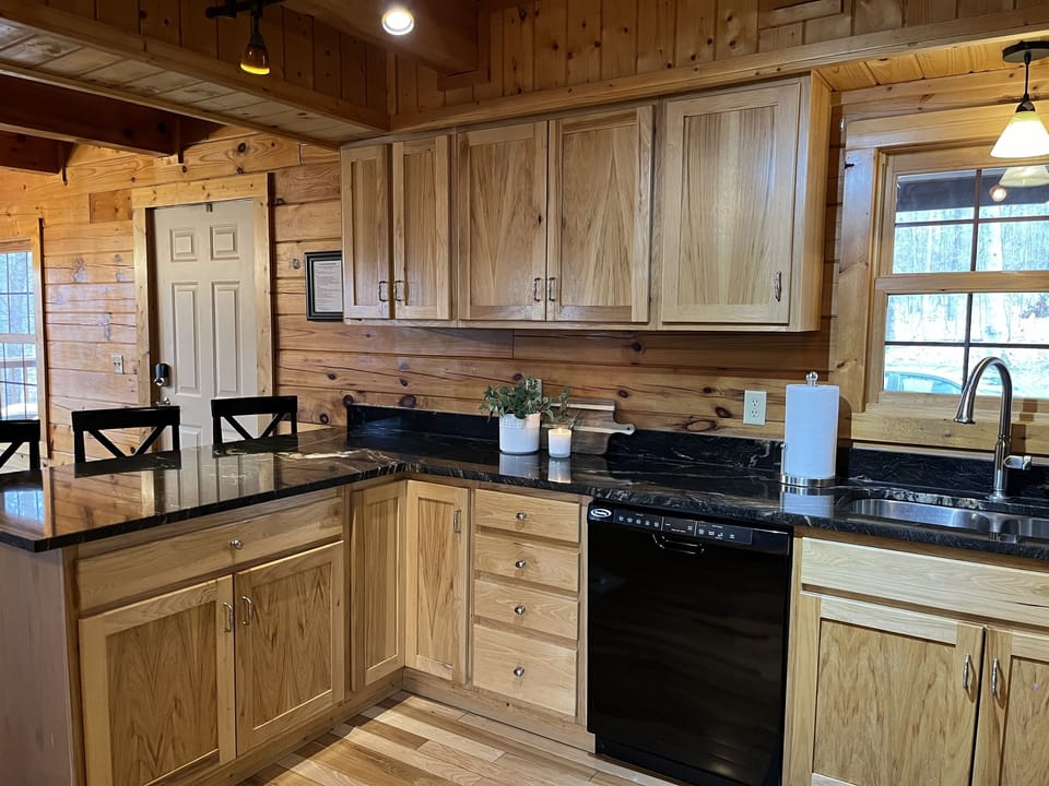 Spacious kitchen with ample counter space, modern appliances, and warm wood finishes for a cozy and functional cooking experience.
