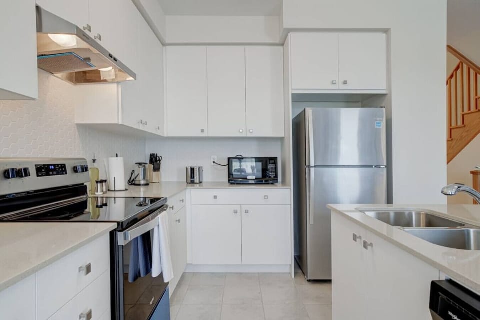 Start your day in a bright, modern kitchen where stainless steel appliances and polished countertops invite you to cook, create, and gather, making every moment feel effortlessly at home.