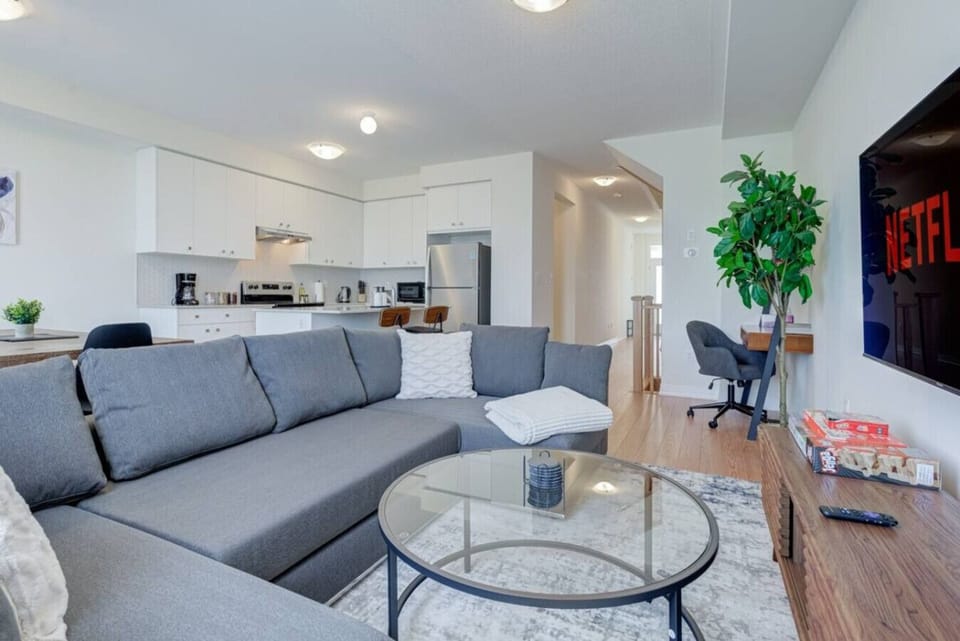 Enjoy the perfect blend of comfort and convenience in this open-concept living space, where a spacious sectional invites you to relax, the fully equipped kitchen is ready for your favorite meals, and the large-screen TV with streaming keeps you entertaine