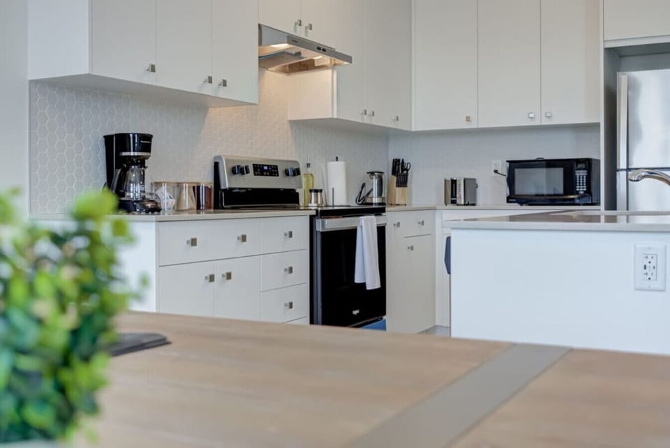 Wake up to the smell of fresh coffee and step into a kitchen designed for both comfort and creativity, where sleek finishes and thoughtful touches make cooking a joy and every meal feel like a special occasion.