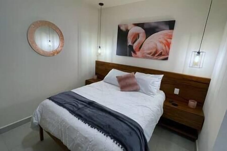 The Flamingo room with a queen size bed and spacious personal work space.
