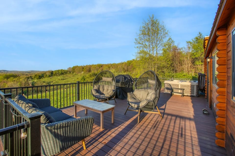 Spacious deck with cozy seating, grill, and hot tub