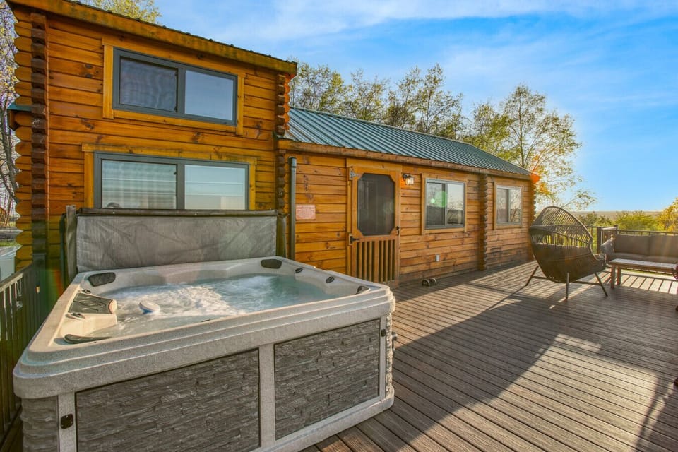 Exterior deck with a hot tub and outdoor seating