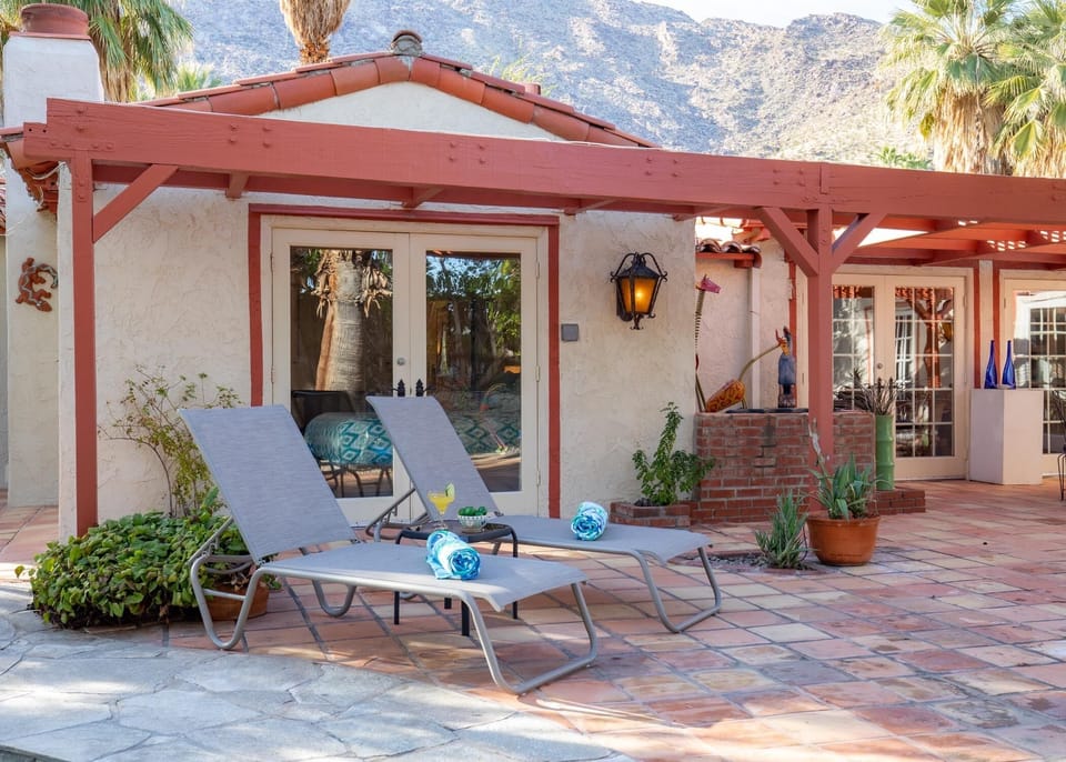 Backyard by the pool with several lounge chair options
