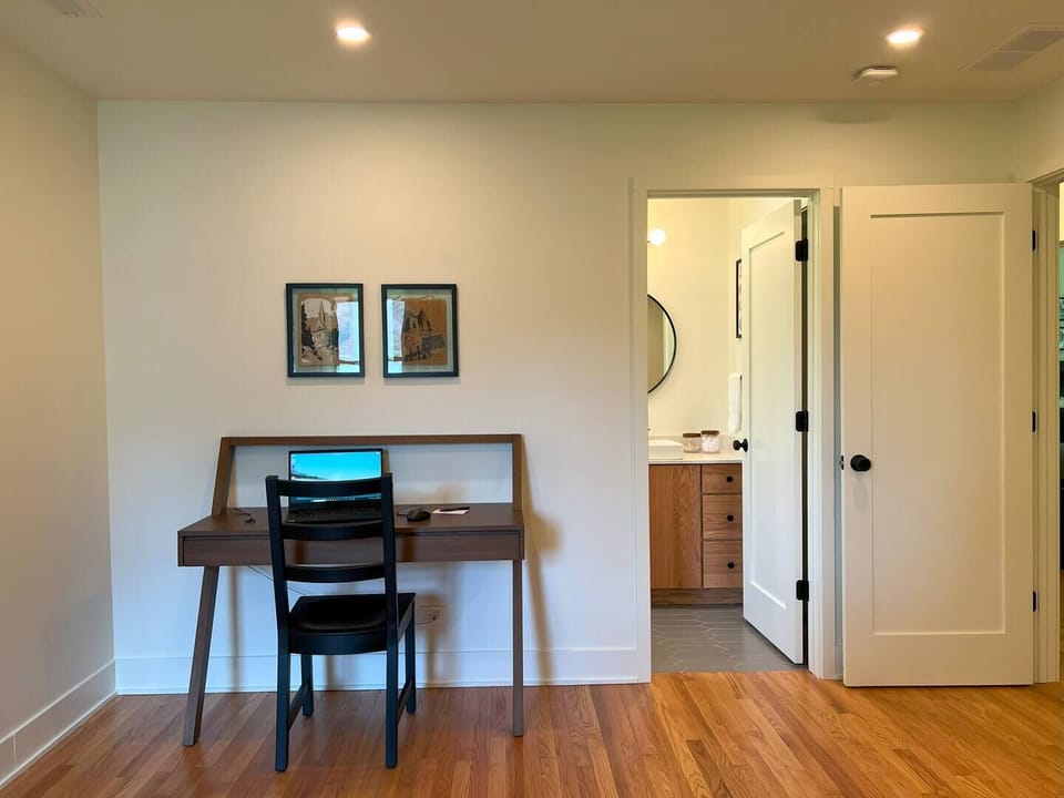 desk and bathroom entry within primary bedroom