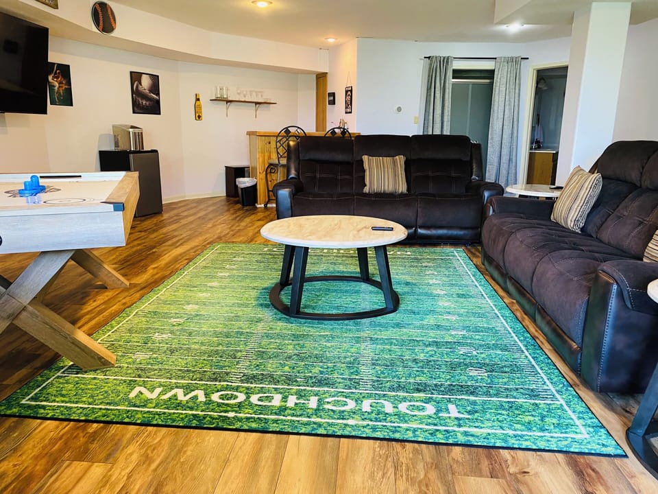 Game room/mancave with big screen TV, air hockey, wet bar.