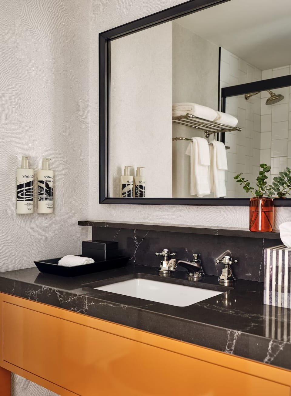 Refresh at the sleek vanity with spa-style amenities.