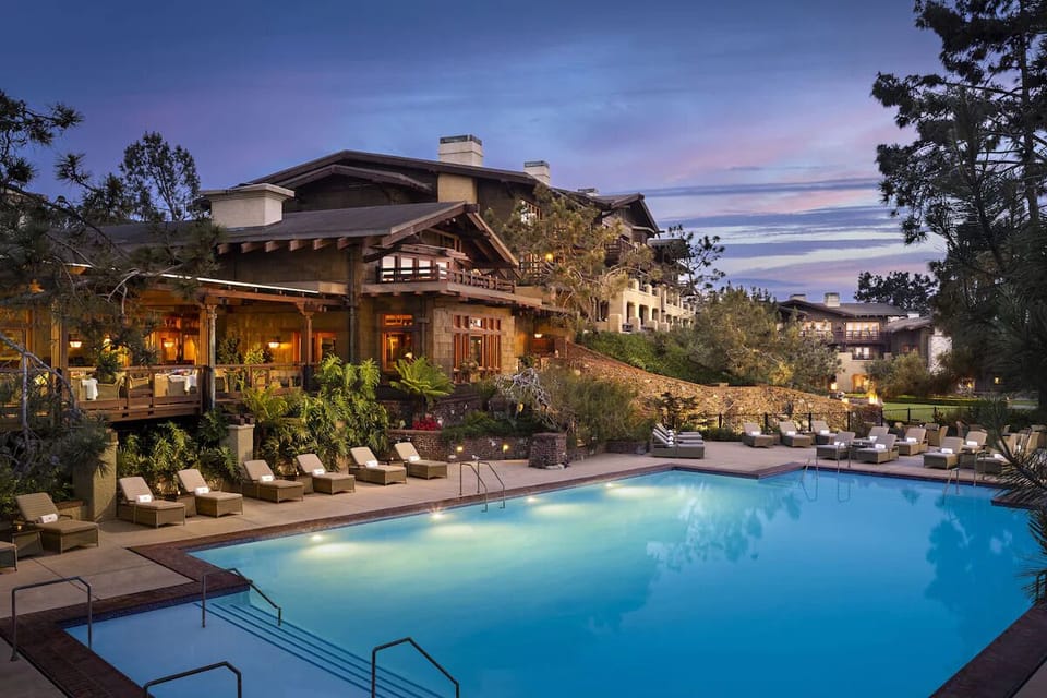 Unwind poolside at dusk with glowing lights and loungers.