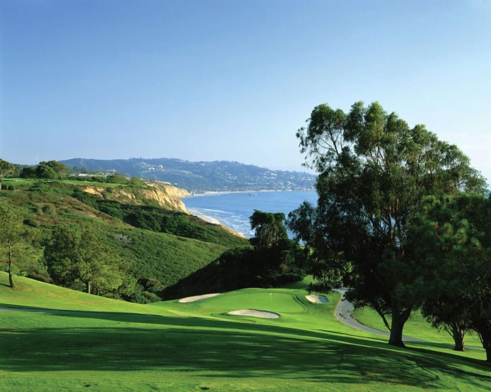 Soak up panoramic coastal views from immaculate championship fairways.