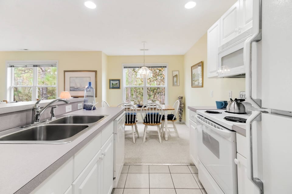 Spacious kitchen with stove, microwave, dishwasher and refrigerator