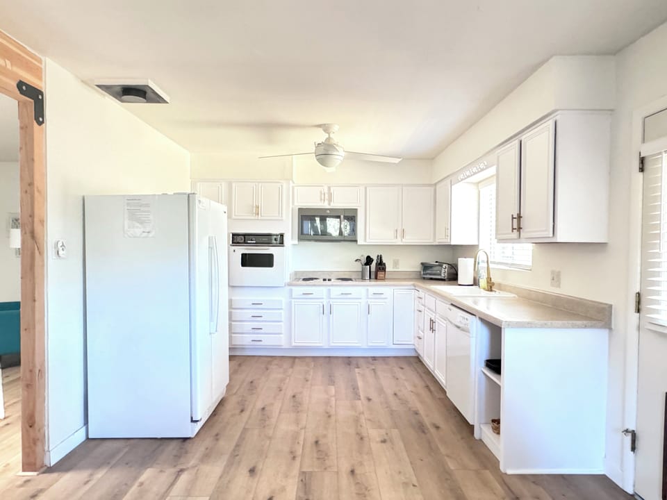 Open kitchen is well stocked with cooking implements and basic ingredients.