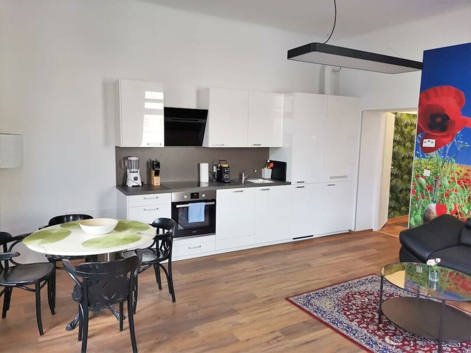 Step into the living room, where Arbio Designers` expertise shines through, creating a warm and inviting atmosphere, perfect for socializing or watching TV.