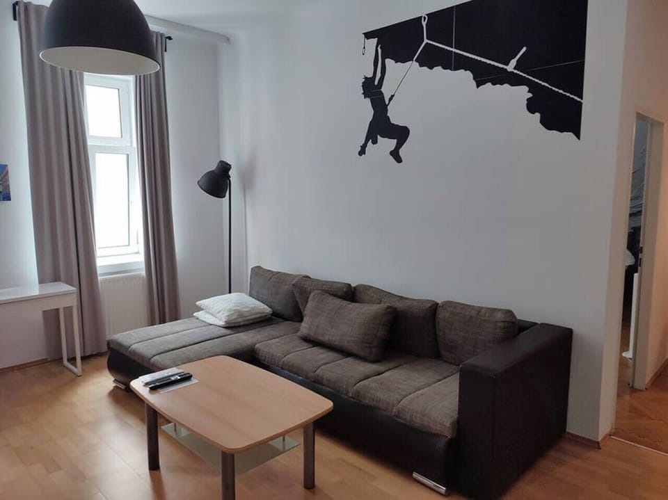 Step into the living room, where Arbio Designers` expertise shines through, creating a warm and inviting atmosphere, perfect for socializing or watching TV.