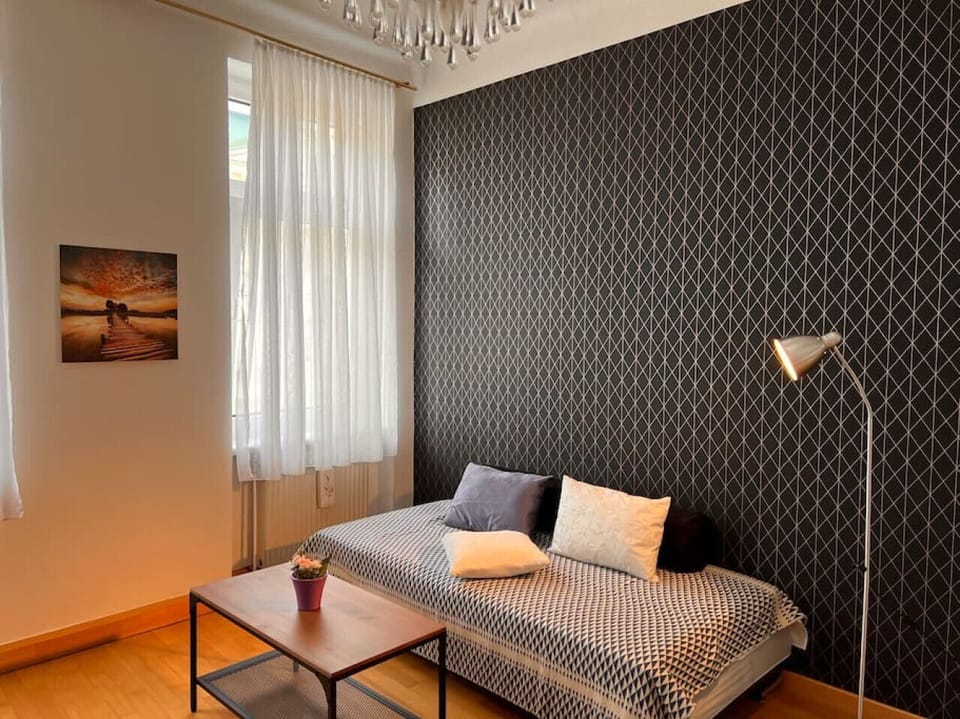 Your living room, a hub of daily activities and conversation, adorned by Arbio Designers, offering comfortable seating and a welcoming ambiance.