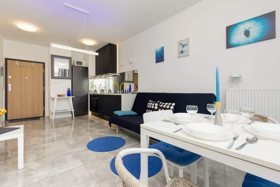 Another perspective of the living-dining area, highlighting the cohesive design and blue-themed decor.
