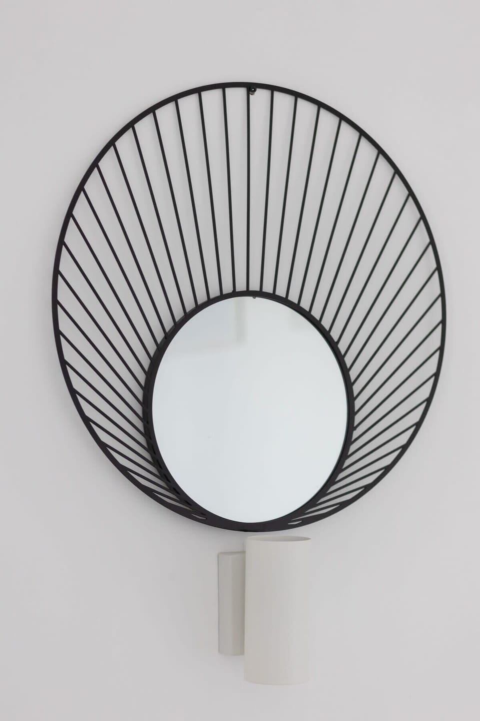 A close-up of a decorative wall mirror, adding a unique and modern touch to the space.
