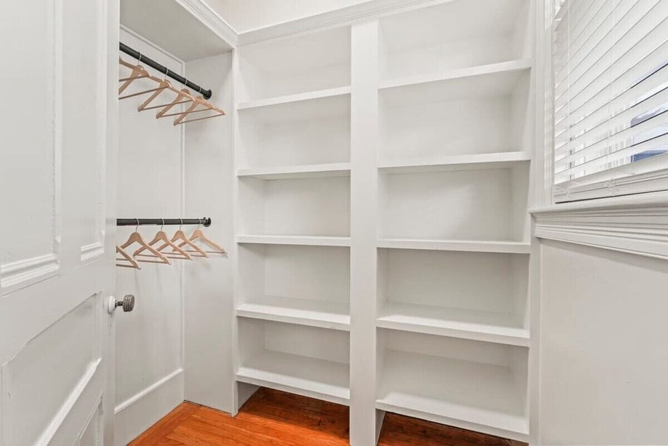 Master Walk-In Closet with Built in Shelving and Two Levels of Hanging bars