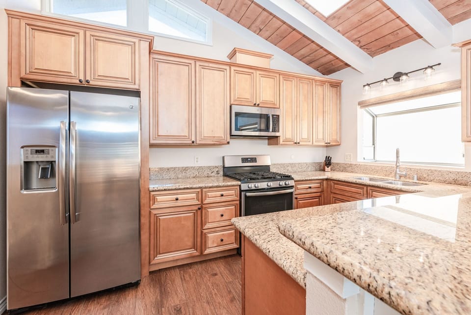 The upper residence kitchen offers a bright, thoughtfully designed culinary space
                