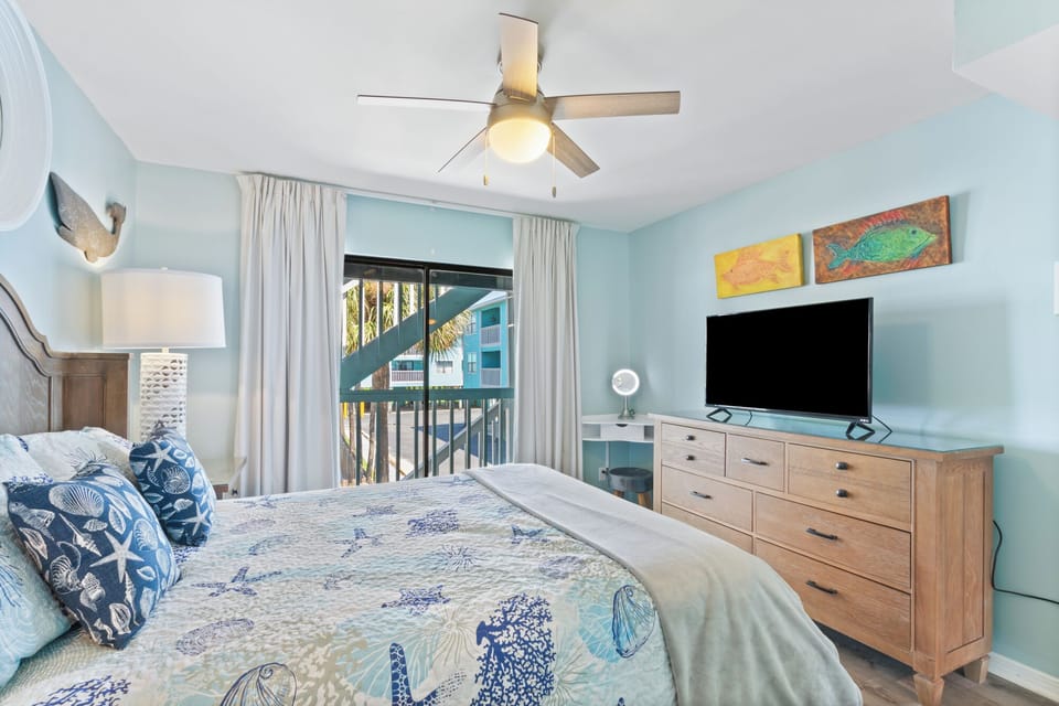 This bedroom has a queen bed as well as a TV