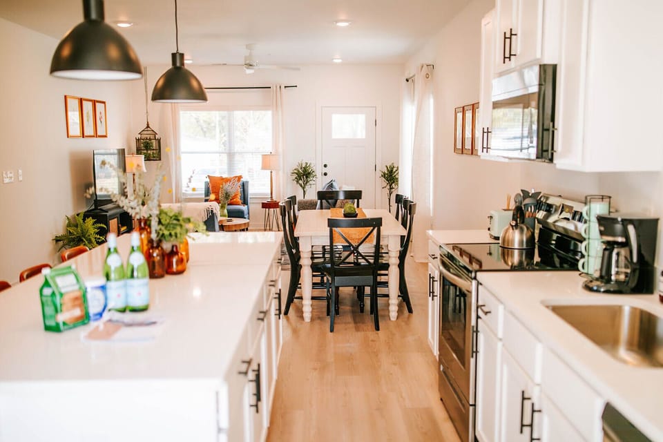 We love this open layout! It’s the perfect spot to keep the conversation going while you’re prepping a meal or grabbing a snack. We hope it makes your group’s stay in The Classic City even more comfortable.