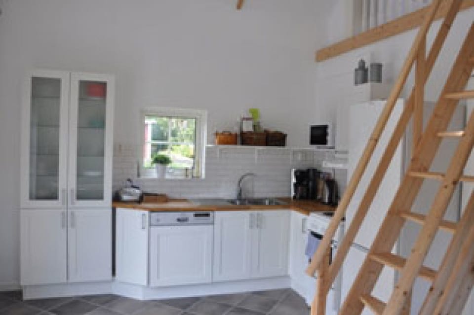 kitchen with all modern facilities as dish washer, microwave, coffee mashine, water boiler, refridgerator and freezer. Seating is available both inside and outside for meals.