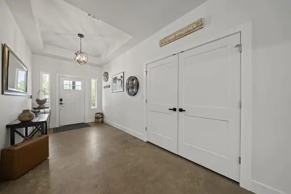 Bright, welcoming foyer with a statement pendant light & a reminder to gather together.