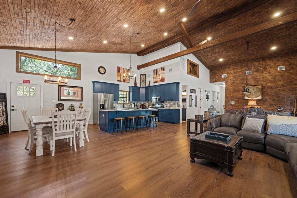 Living Room & Kitchen: Spacious open layout with modern décor and elegant wooden accents!