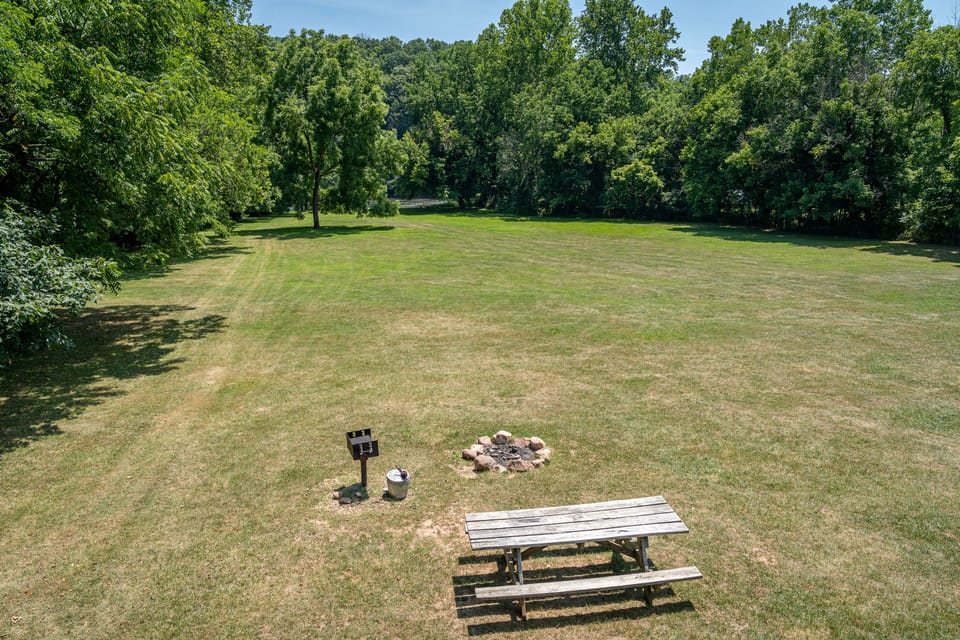 Charcoal grill & fire pit by table with view to the river