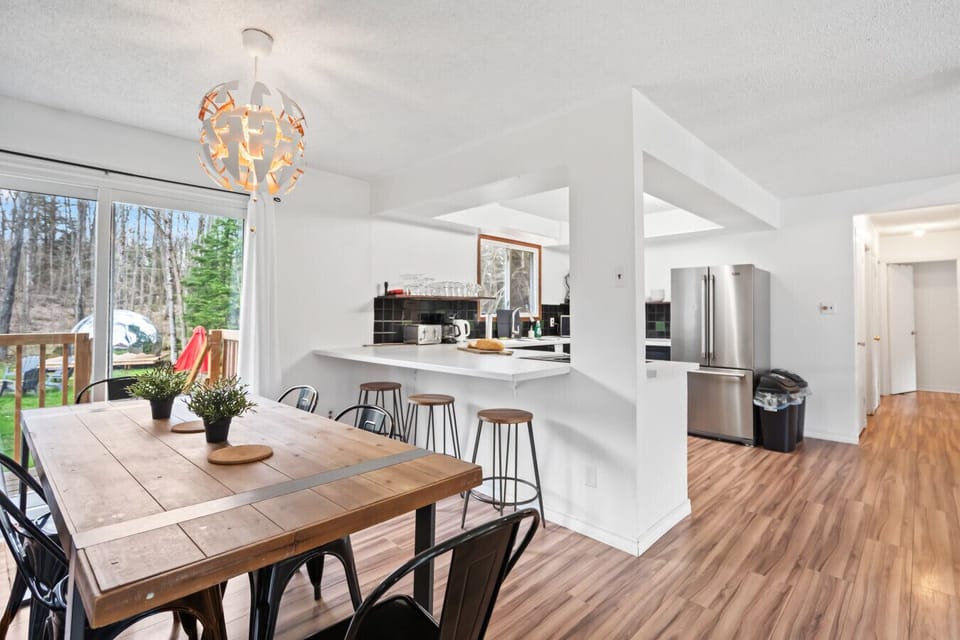 Spacious dining area seats 10 with extra barstools at the kitchen counter and a beautiful backyard view!