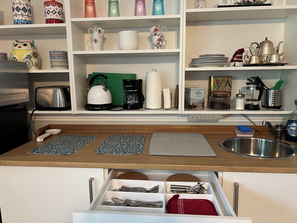 Kitchenette stocked with dishes and utensils