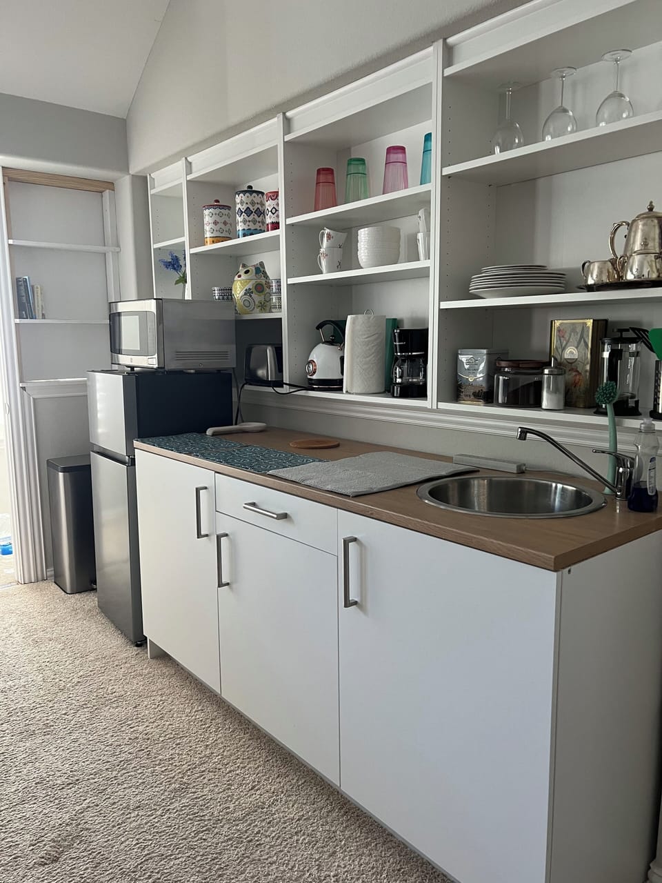 Kitchenette with refrigerator, sink and coffee maker