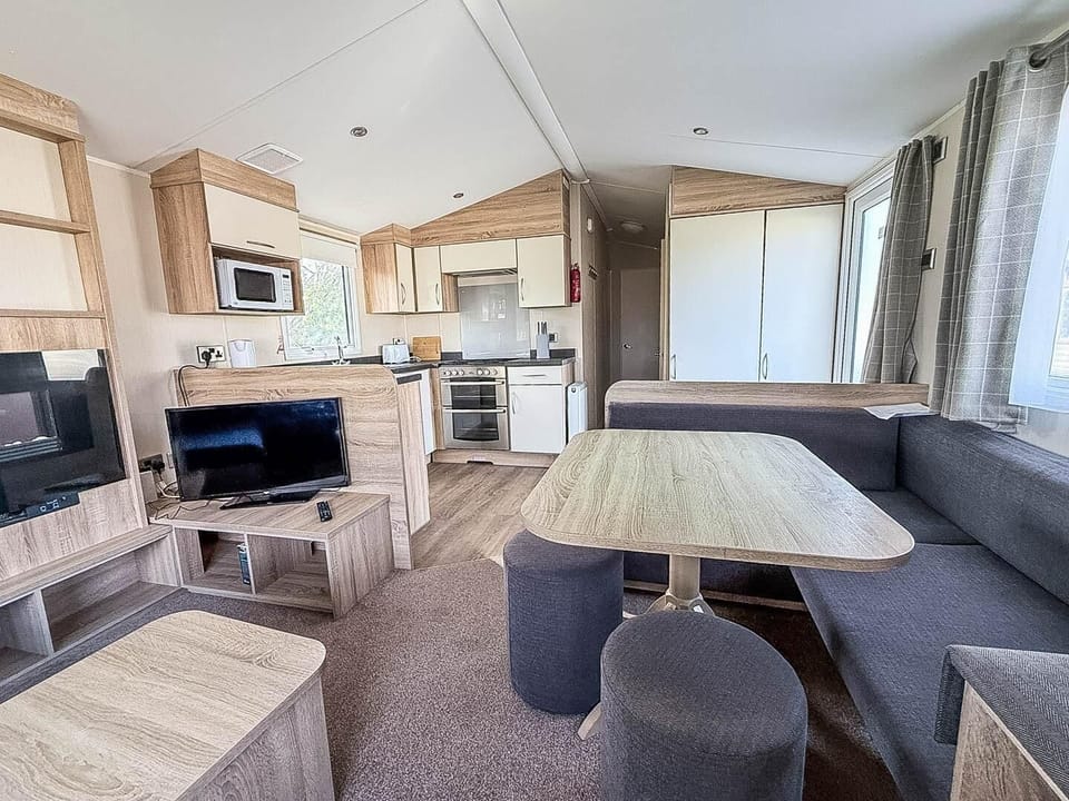 Relax in the living room of a caravan at Broadland Sands Holiday Park Lowestoft, the ideal spot for a UK staycation near Lowestoft beach and Corton beach Lowestoft.