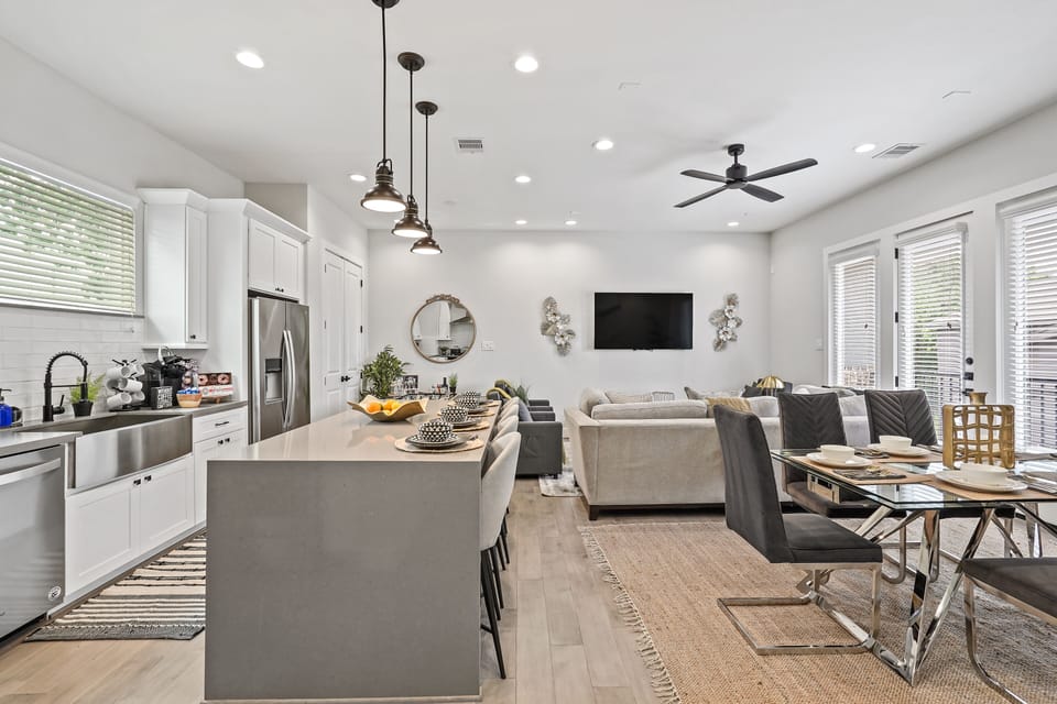 Stylish open-concept kitchen, dining, and living area with modern design.