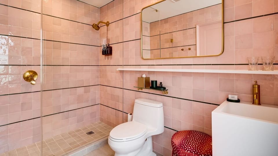 Refresh in a blush-tiled bath with sleek, spa-like fixtures.