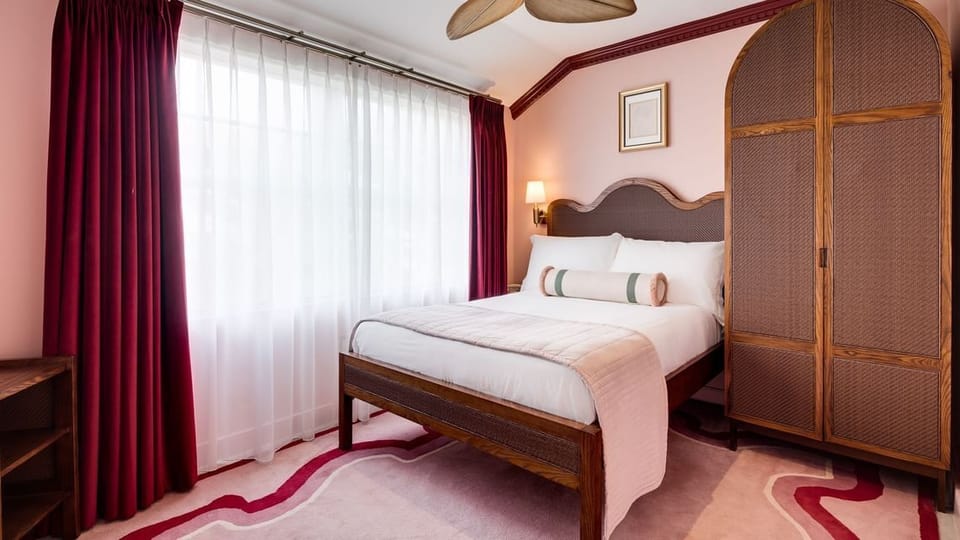 Sink into plush pillows in this serene, softly draped retreat.