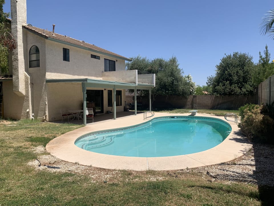 Pool with diving board, patio, & 2nd story deck off of the master bedroom.