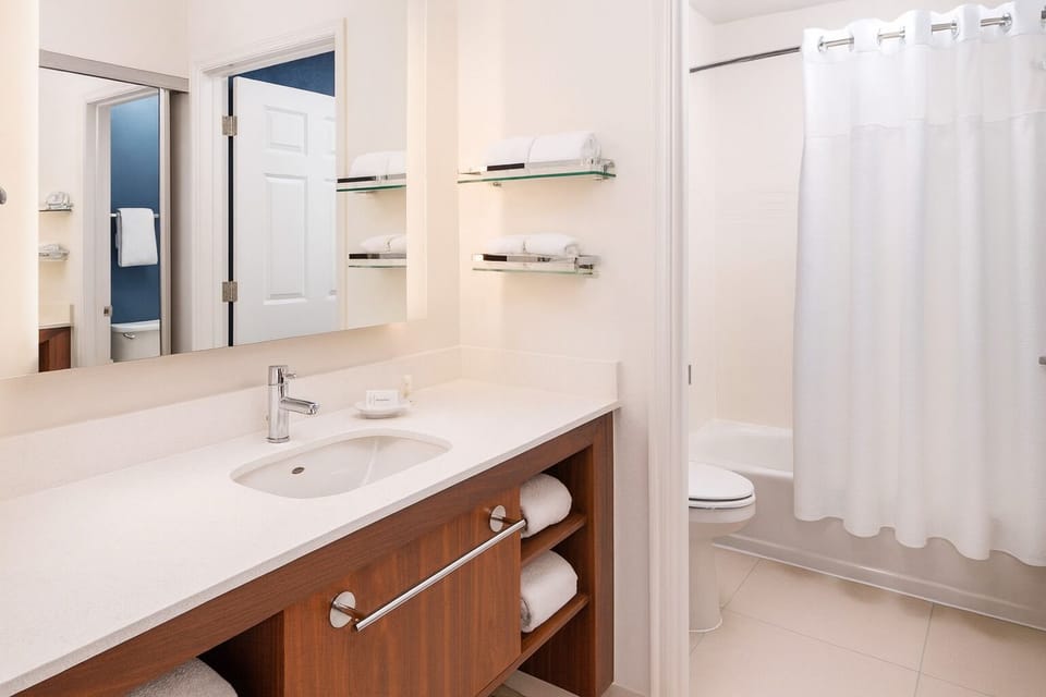 Refresh comfortably at the wide vanity with bright, clean finishes.