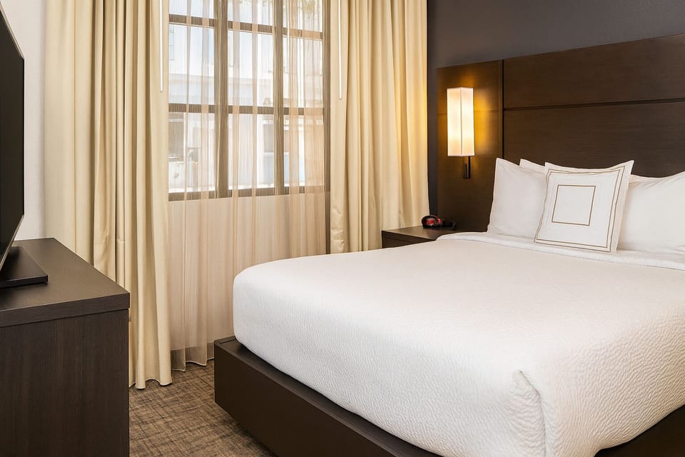 Sink into a cloud-soft king bed by sunlit windows.