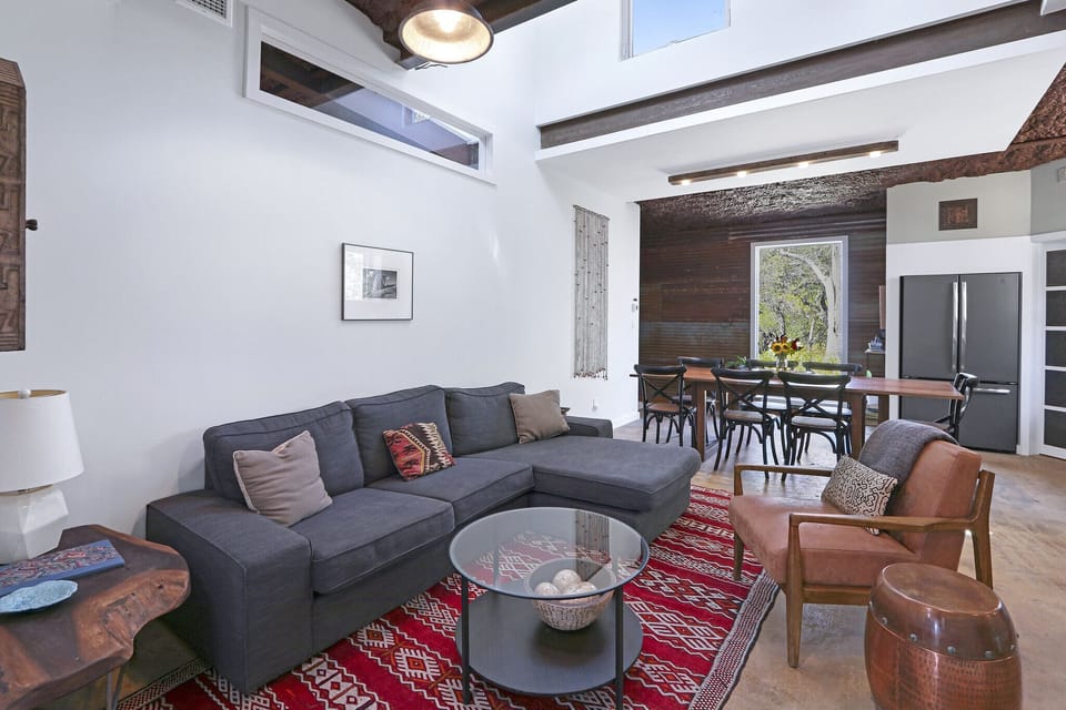 Behind the living area is the dining and kitchen