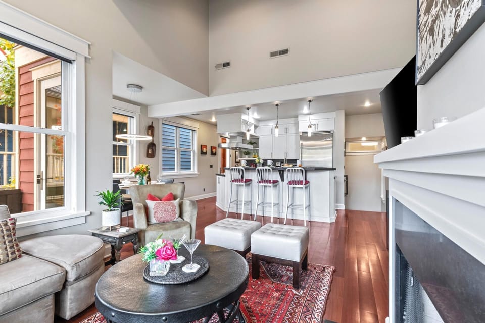 An alternate living view shows leather seating, Smart TV, and fireplace, ideal for winding down.