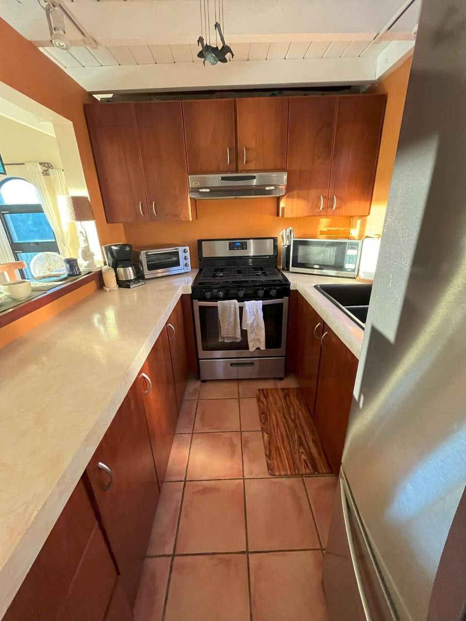 The galley kitchen with full-sized oven and fridge. New microwave coming soon!