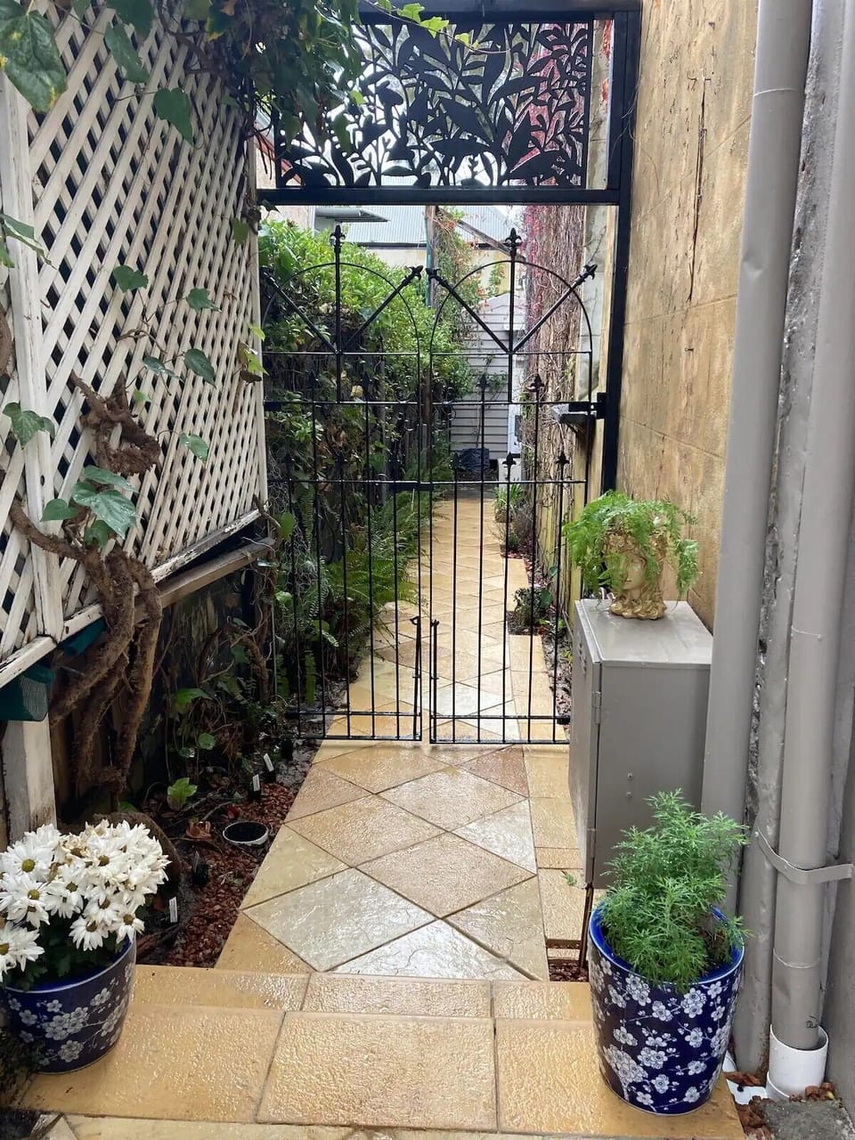 Side Entrance and pathway to Tiny House Studio with fully secured locked gate.