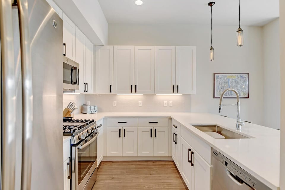 Kitchen with Large Counter Bar Area, Stove, Dishwasher, Refrigerator, and Microwave