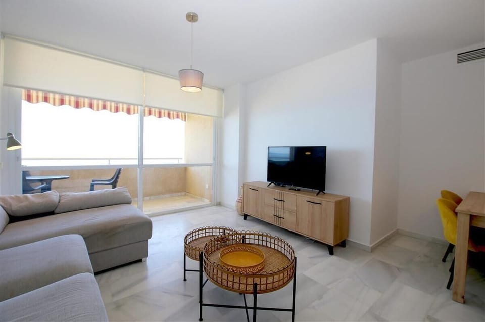 Another image of the living room with international TV and access to the terrace