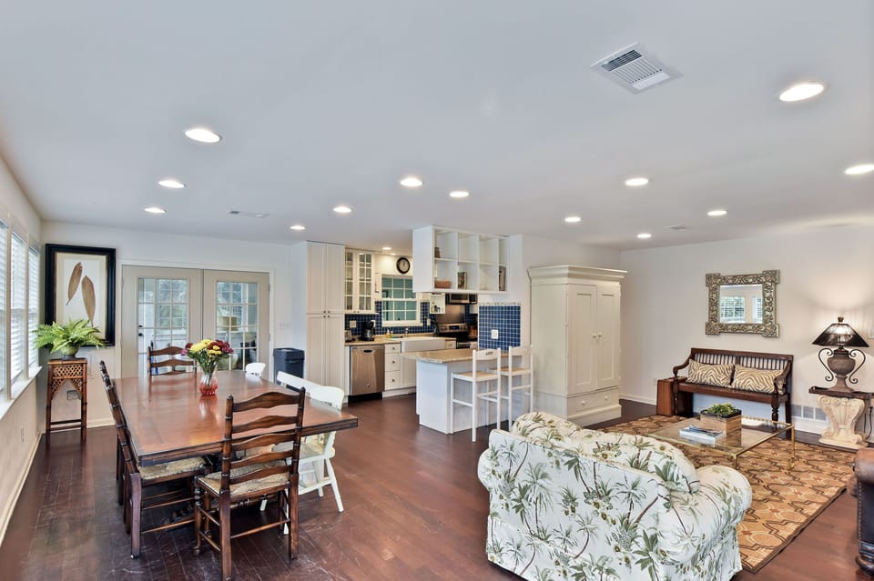 Dining Room with Long Table - Long dining table by French doors seats the group near the kitchen and living room.