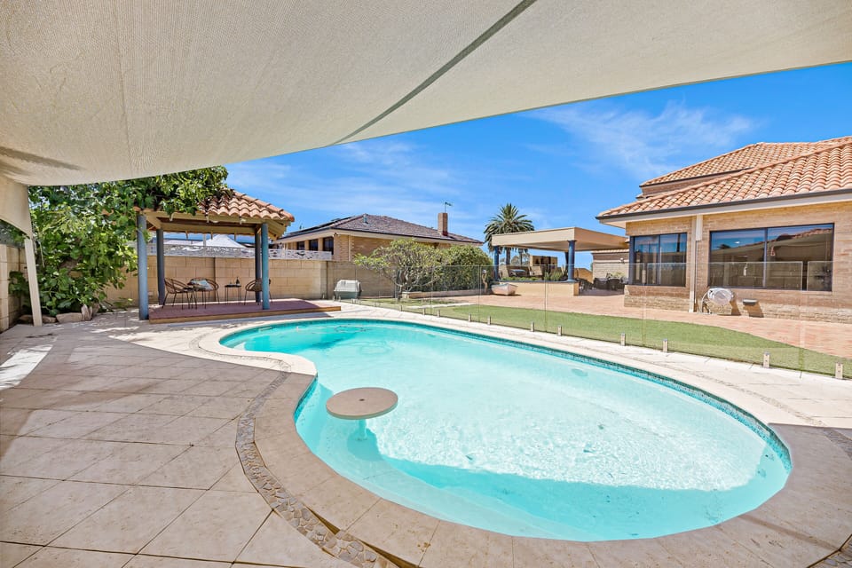 Take a refreshing dip in the sparkling swimming pool, perfect for cooling off on a hot day.