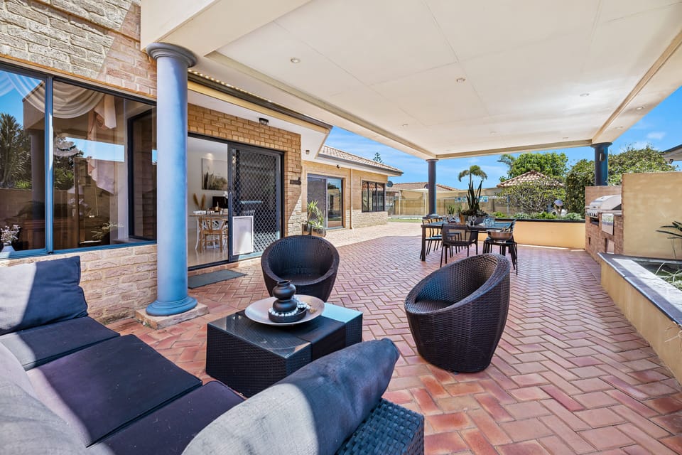 Relax and entertain in this spacious outdoor lounge area, featuring comfortable seating perfect for enjoying the outdoors.